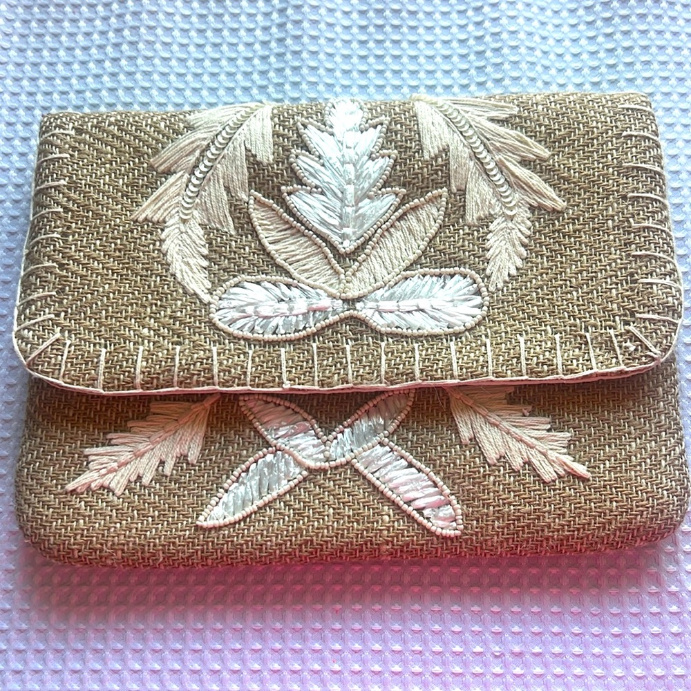 Beige clutch bag be the details